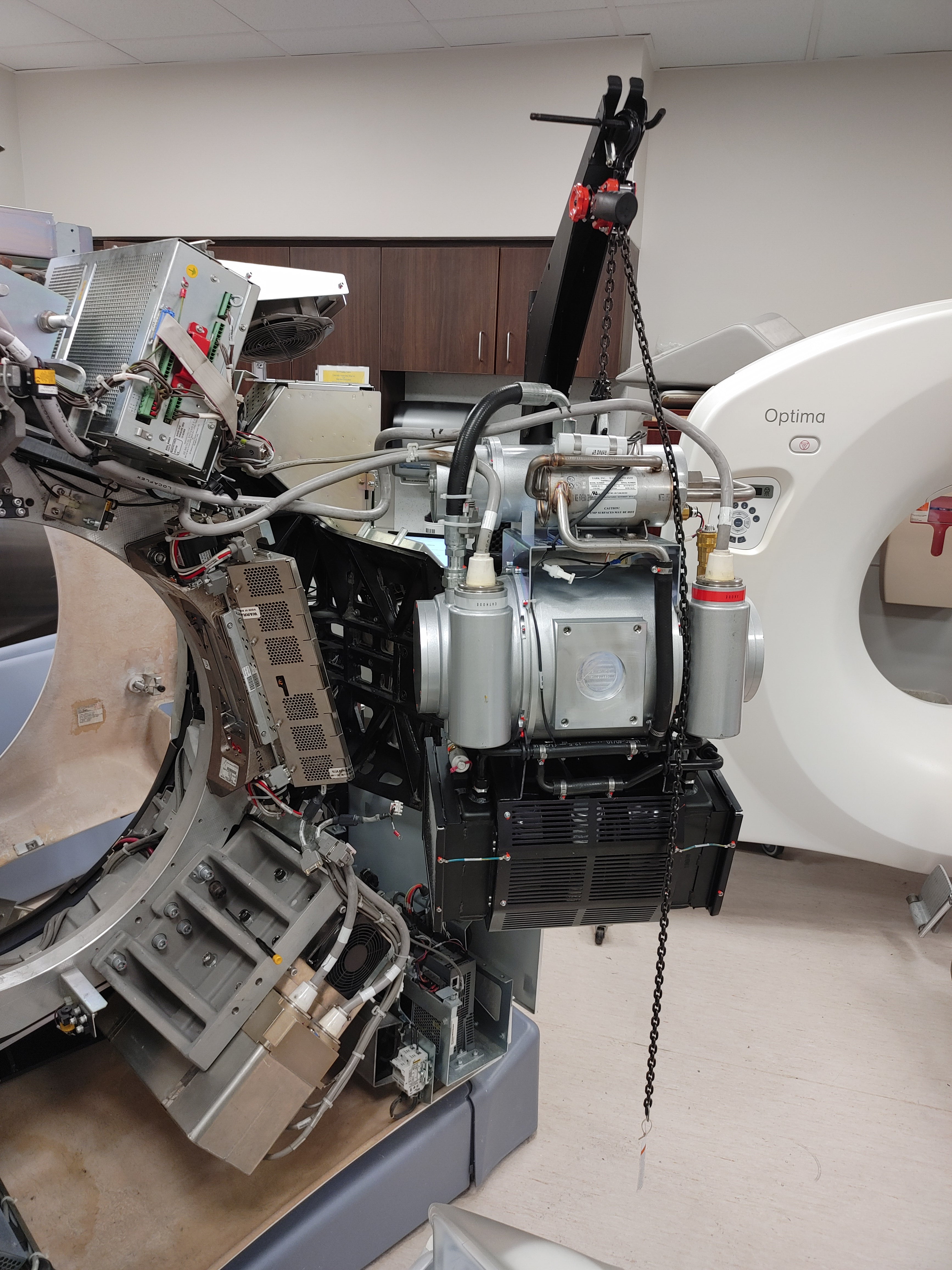 GE Optima CT scanner service and repair with covers removed showing internal components – FDM Enterprises field service