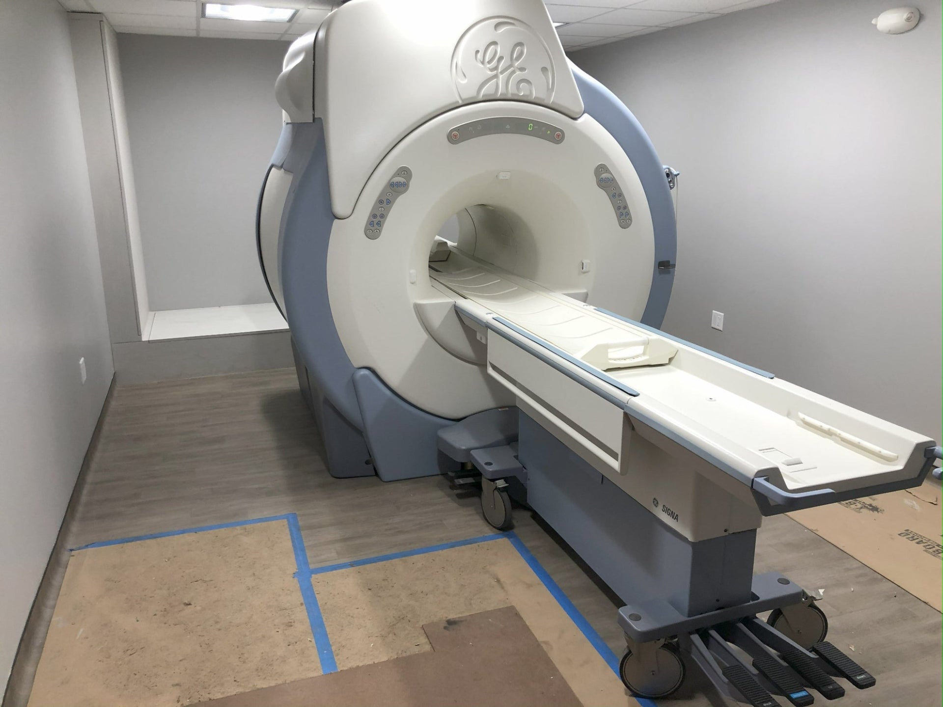 MRI technician servicing a GE MRI scanner — FDM Enterprises diagnostic imaging repair