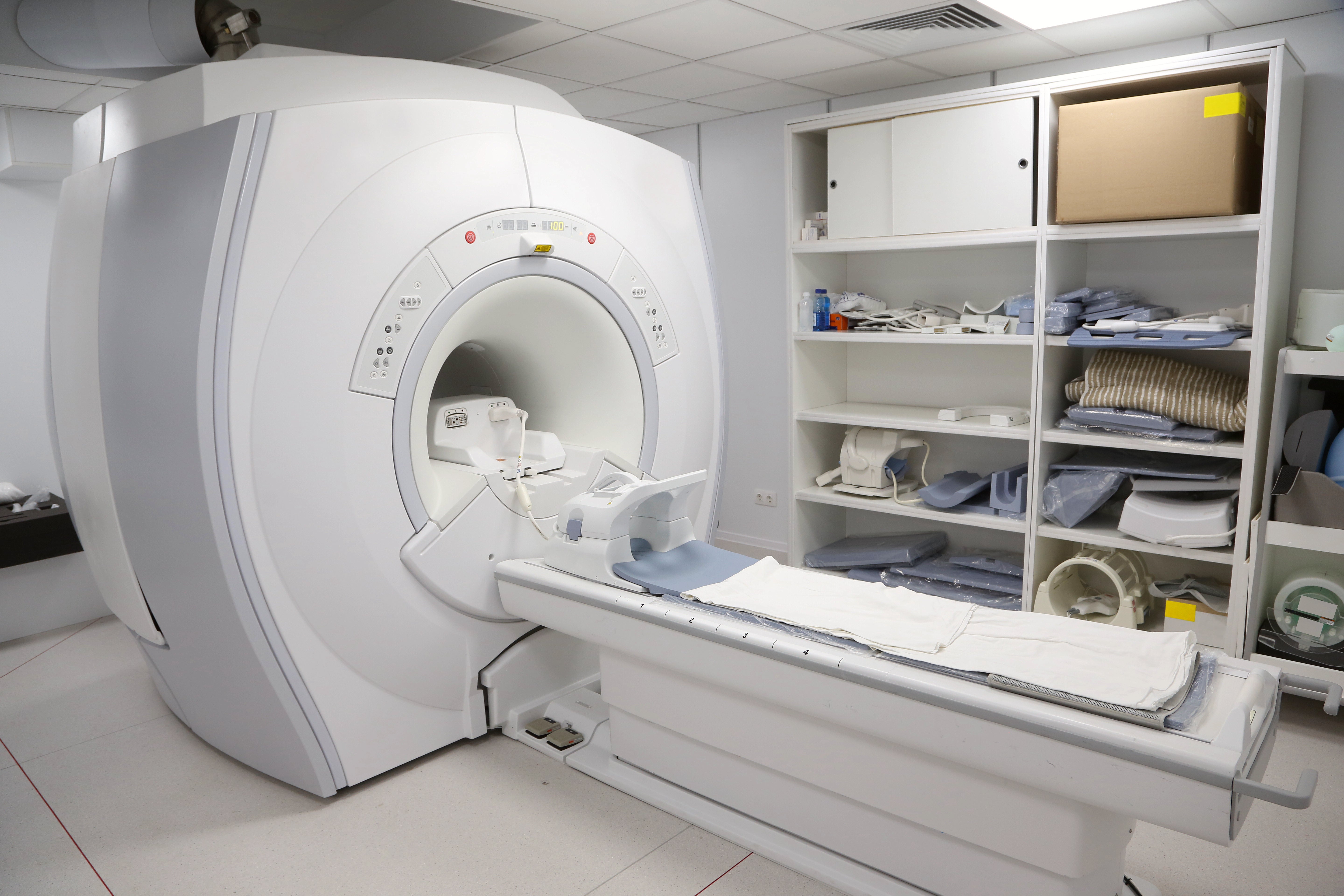 MRI machine with patient coils and accessories in imaging suite