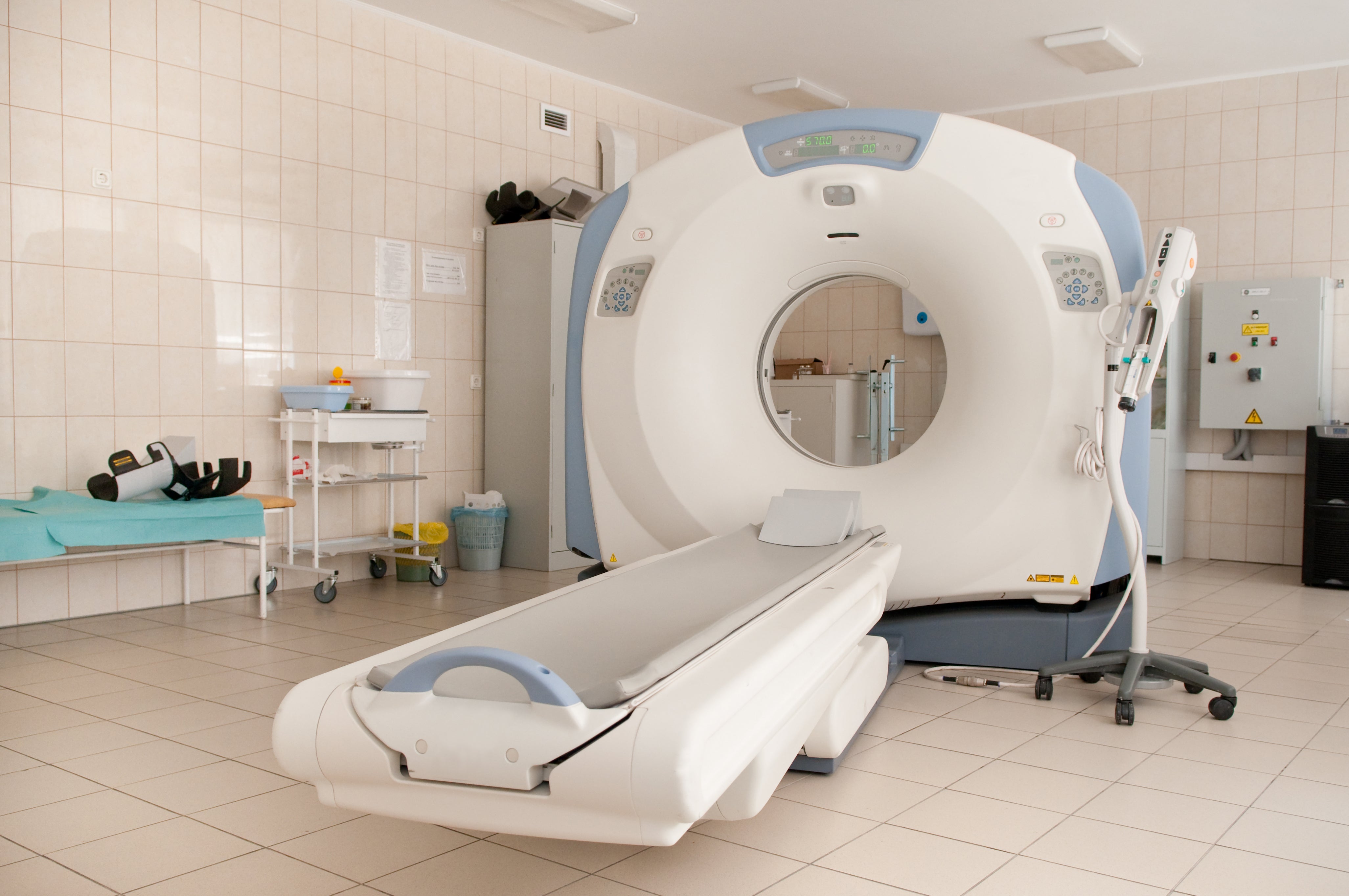 CT scanner with patient table in hospital diagnostic imaging department