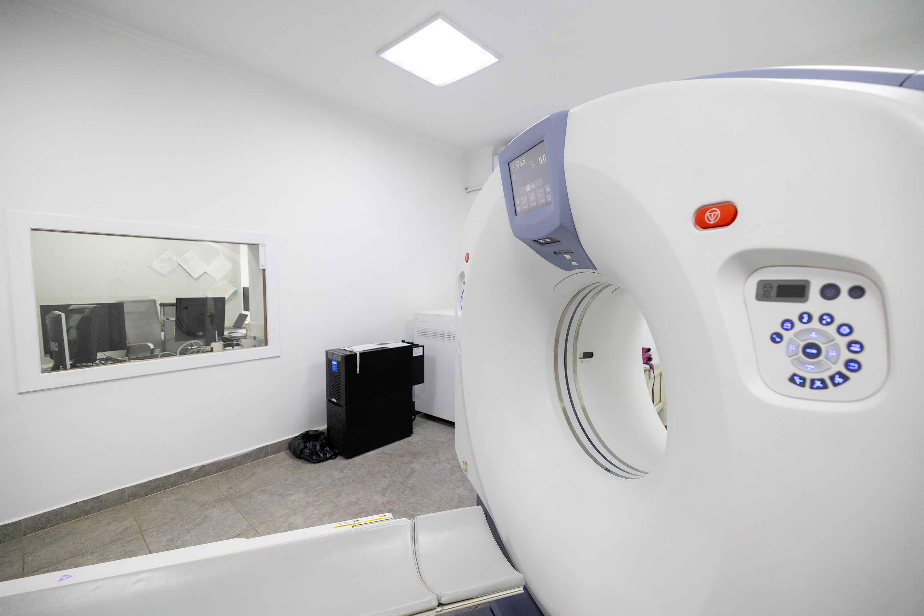 CT scanner with operator window and control console in imaging facility